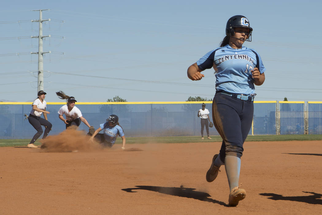 Centennial senior Brianna Benoit comes into third base as teammate senior Haylee Lupinetti s ...