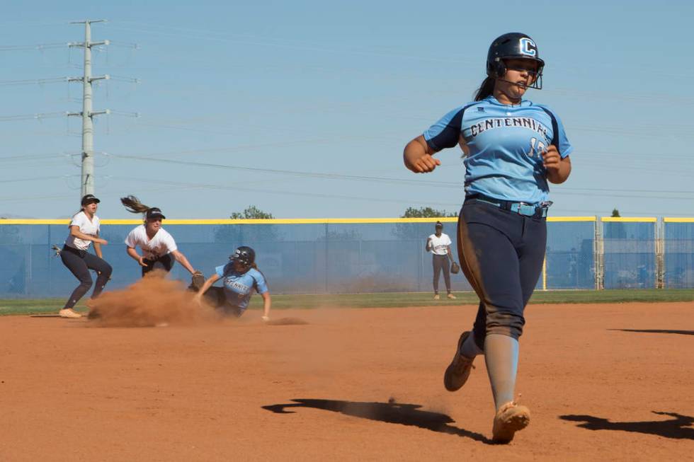 Centennial senior Brianna Benoit comes into third base as teammate senior Haylee Lupinetti s ...