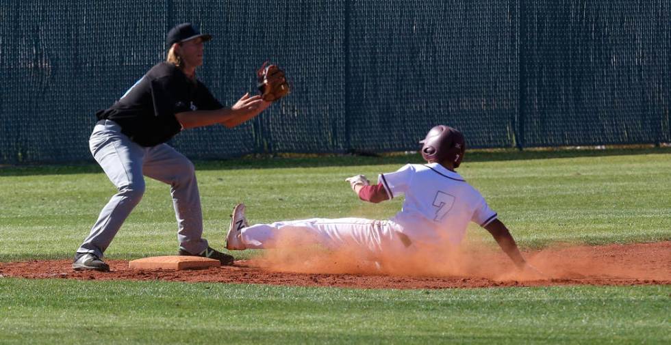 Cimarron-Memorial’s Zach Culver (7) slides for third base during the fourth inning of ...