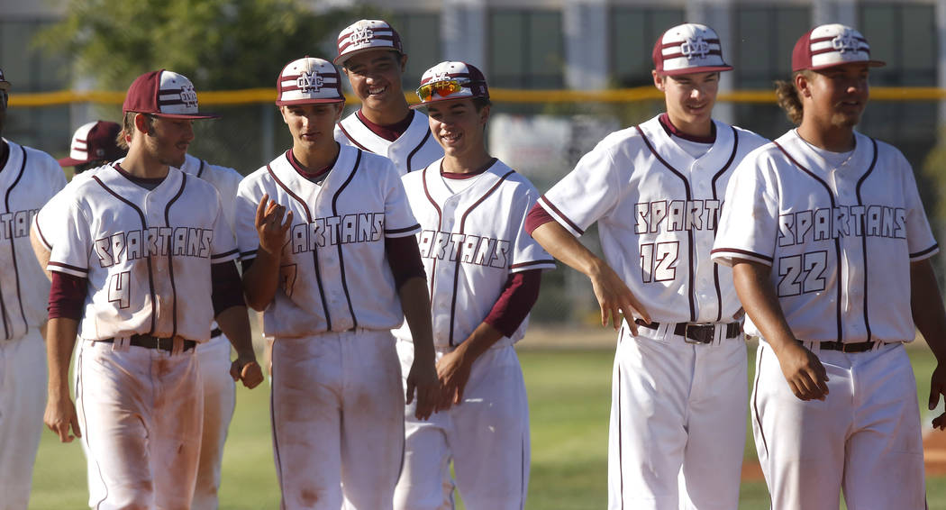 Cimarron-Memorial players walk onto the field after winning a high school baseball game agai ...