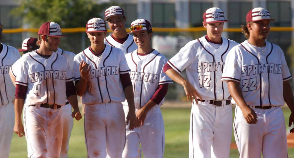 Cimarron-Memorial players walk onto the field after winning a high school baseball game agai ...