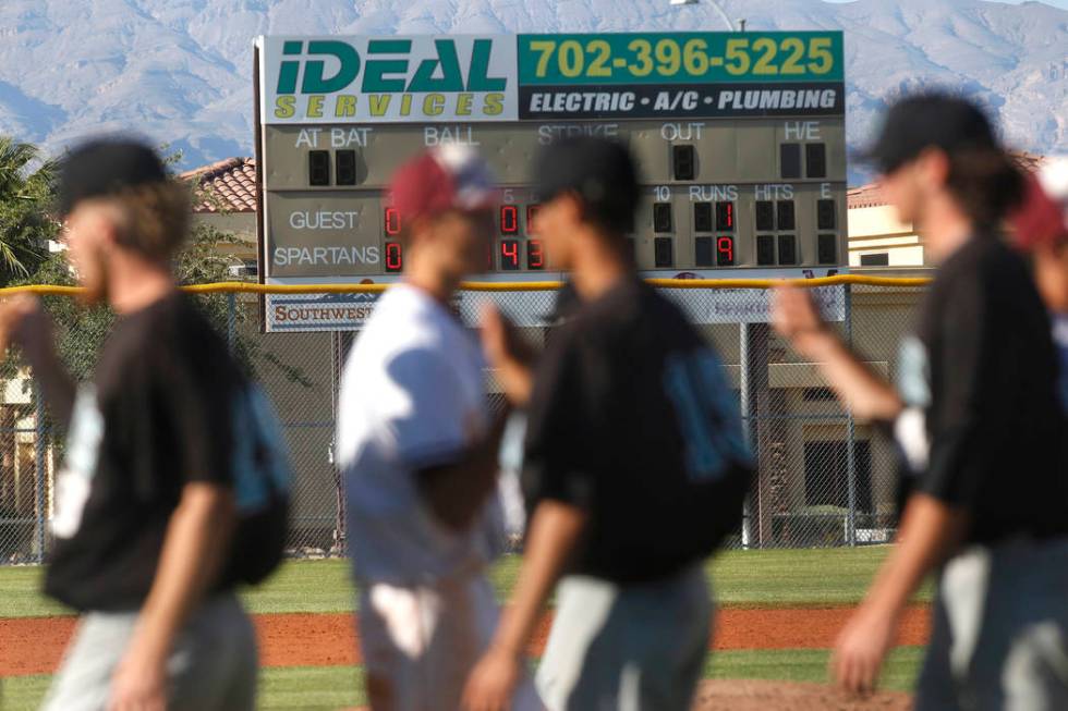 Cimarron-Memorial and Silverado bump fists after a high school baseball game at Cimarron-Mem ...