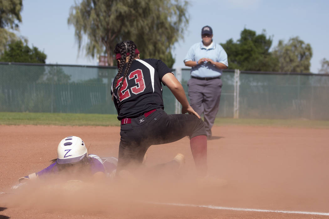 Durango sophomore Kaitlin Fazendin safely slides into third base as Desert Oasis sophomore M ...