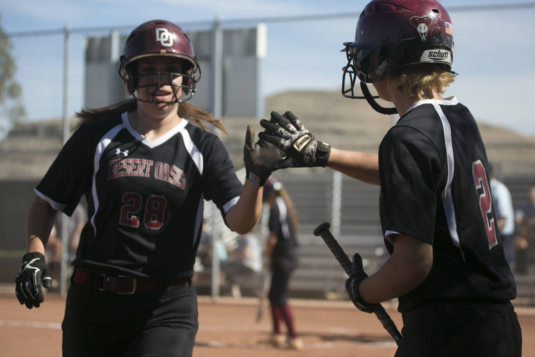 Desert Oasis senior Scarlett Hurtado, left, high-fives teammate senior Meagan Anders, right, ...