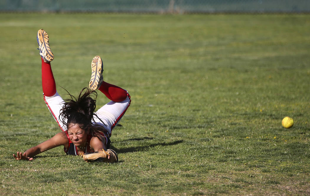 Liberty’s Jasmine Gonzalez (99) misses a fly ball from Foothill during a baseball game ...