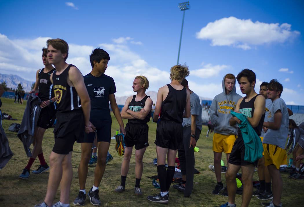 Palo Verde’s Ben Slighting, fourth from left, waits to check in for the 1600-meter run ...