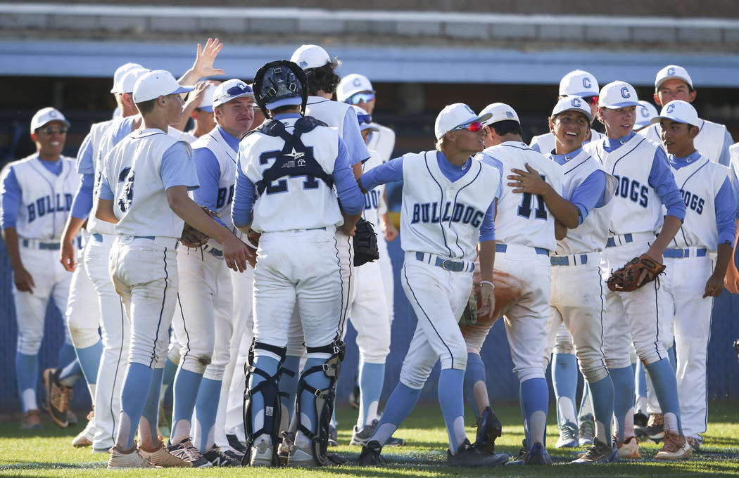 Centennial players celebrate after defeating Desert Oasis’ 11-2 in a Sunset Region bas ...