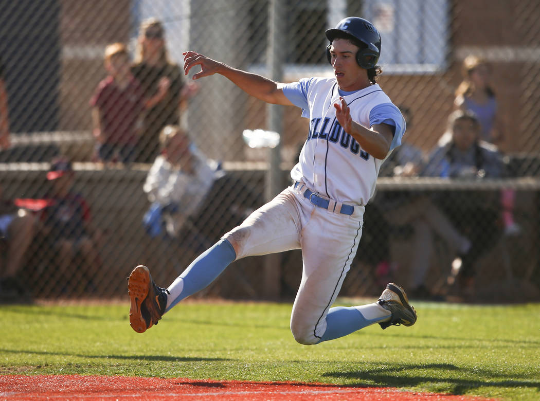 Centennial’s Brett Berger slides into home base to score a run against Desert Oasis du ...