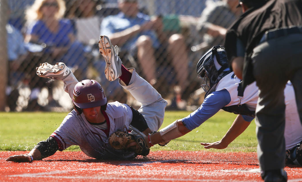 Desert Oasis’ Kyle Fuentes, left, is tagged out by Centennial’s Michael Jones du ...