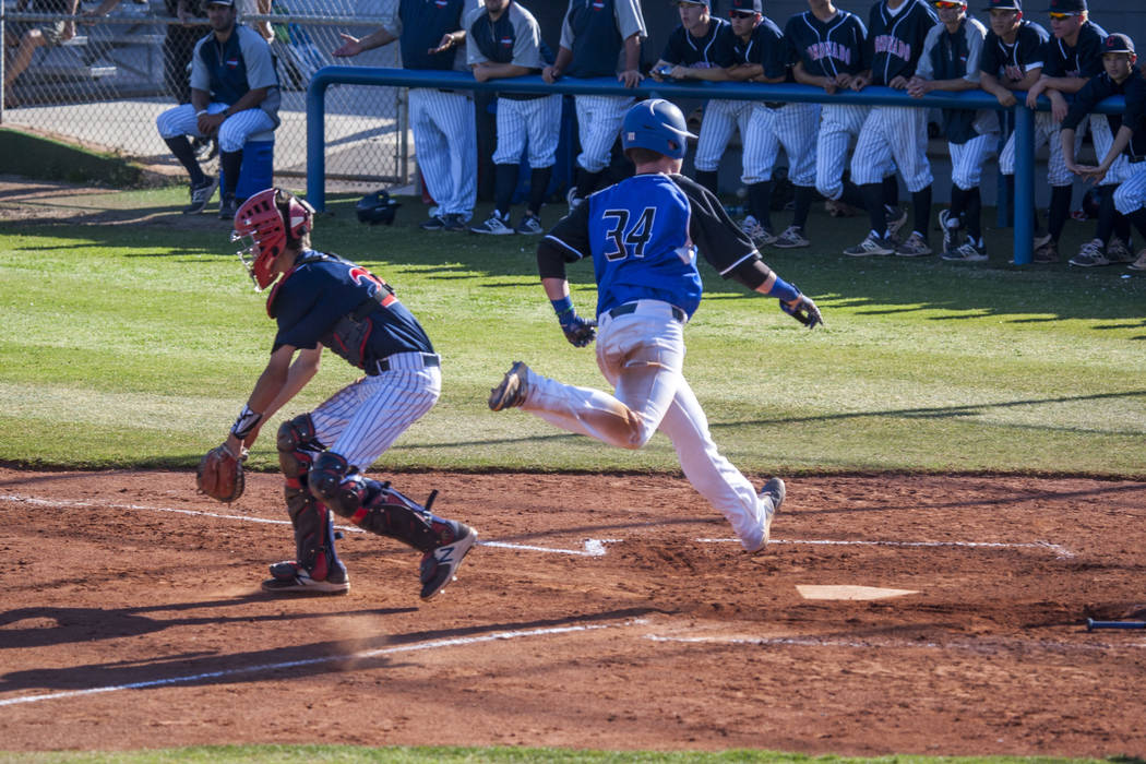 Basic’s Hunter Martin completes a run home again Coronado at Basic High School in Hend ...