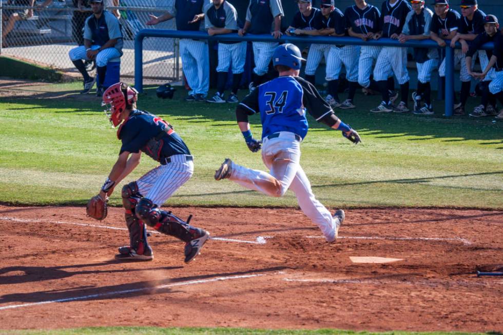 Basic’s Hunter Martin completes a run home again Coronado at Basic High School in Hend ...