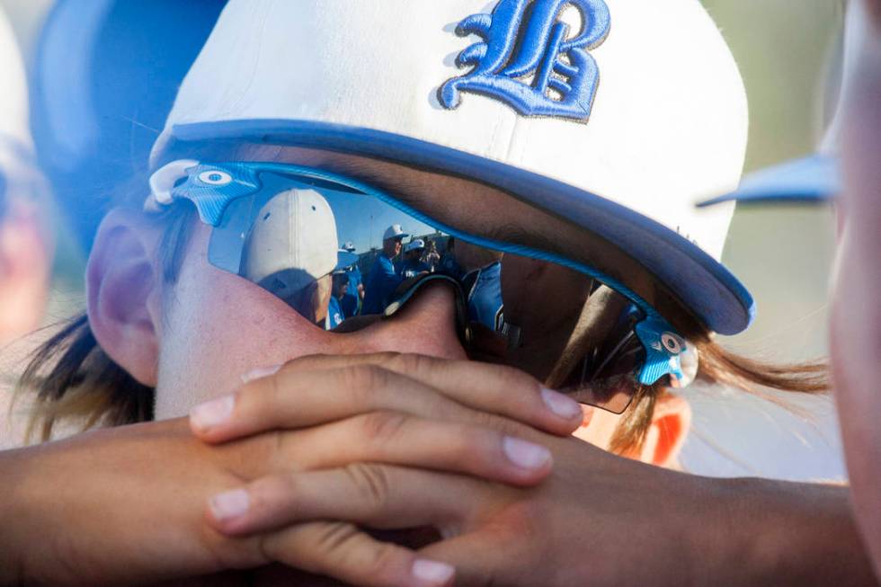 Basic players are reflected in sunglasses during a post-game huddle after their victory agai ...