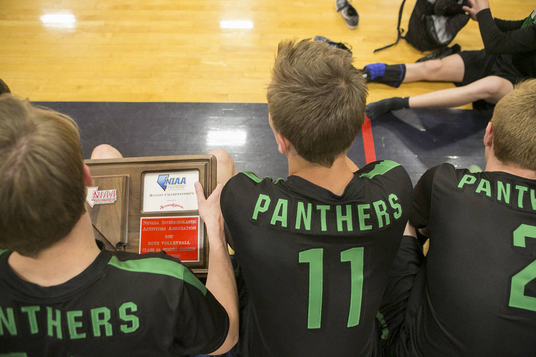 Palo Verde senior Josh Horn (14), left, holds a plaque after the teams win over Centennial a ...