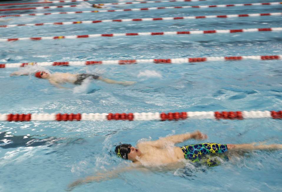 Faith Lutheran’s Michael Fisk , right, competes in the 200 yard individual medley duri ...
