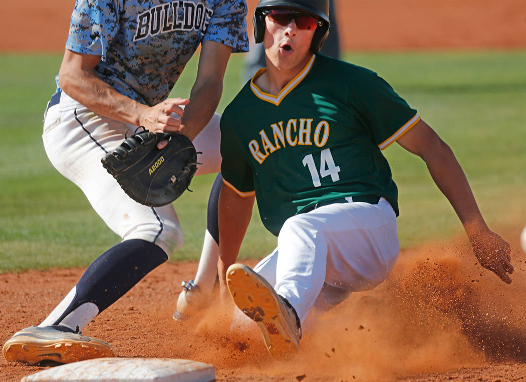 Rancho’s Joseph Walls (14) slides safely back to first base after attempting to steal ...