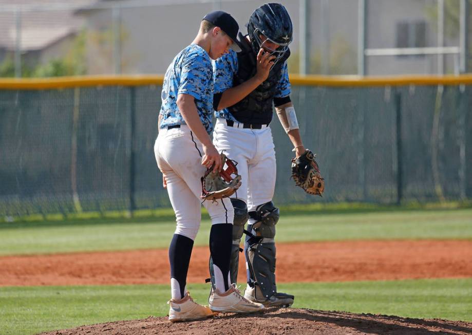 Centennial pitcher Zack Simon, left, talks with catcher Michael Jones during the second inni ...