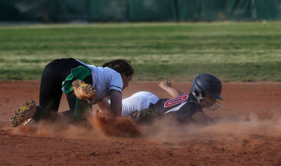 Coronado’s Taylor Okamura (10) avoids getting tagged out by Rancho’s Gianna Caro ...