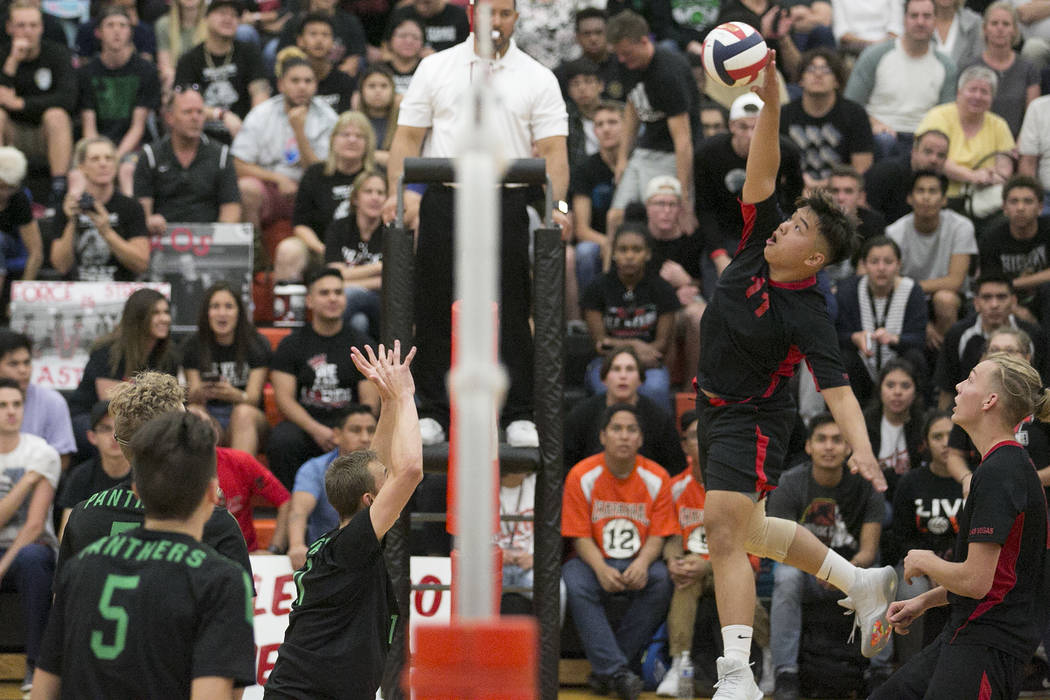 Las Vegas senior Foster Palo (11) hits the ball over the net as Palo Verde attempts to block ...