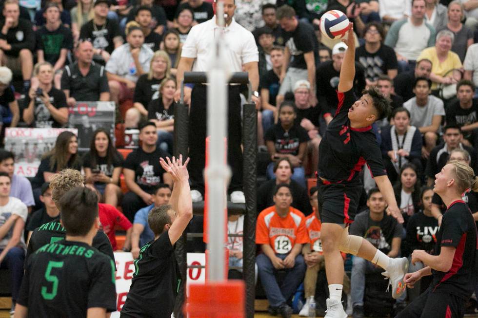 Las Vegas senior Foster Palo (11) hits the ball over the net as Palo Verde attempts to block ...