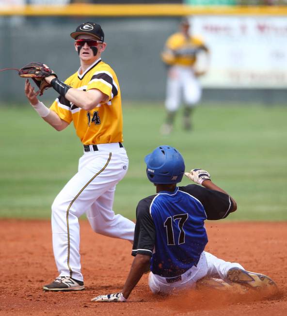 Basic’s Garrett Giles (17) is tagged out by Galena’s Andrew West (14) during a C ...