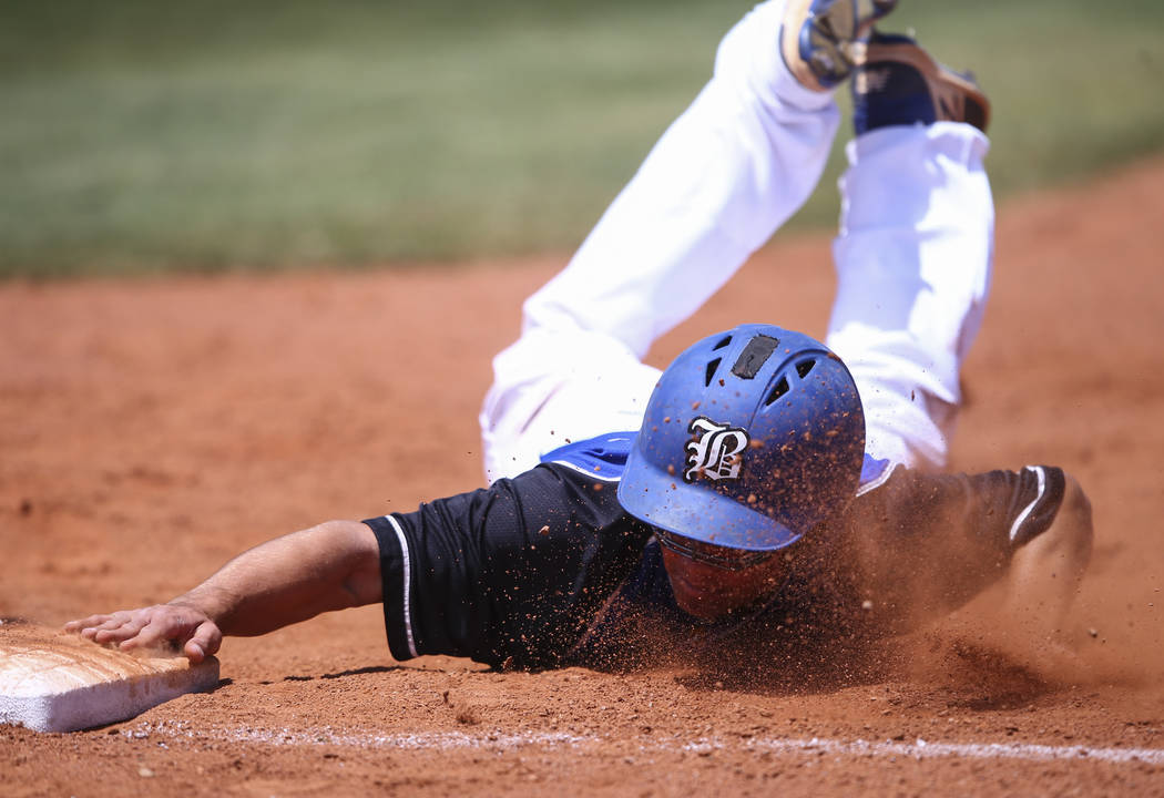 Basic’s Nick Thompson stays safe at first base during a Class 4A state baseball tourna ...