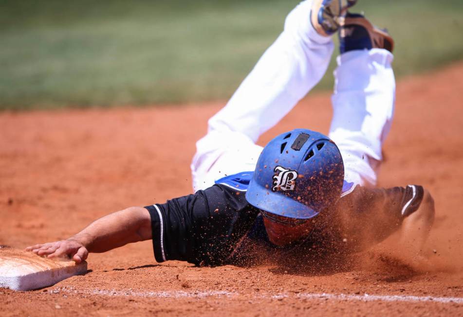 Basic’s Nick Thompson stays safe at first base during a Class 4A state baseball tourna ...