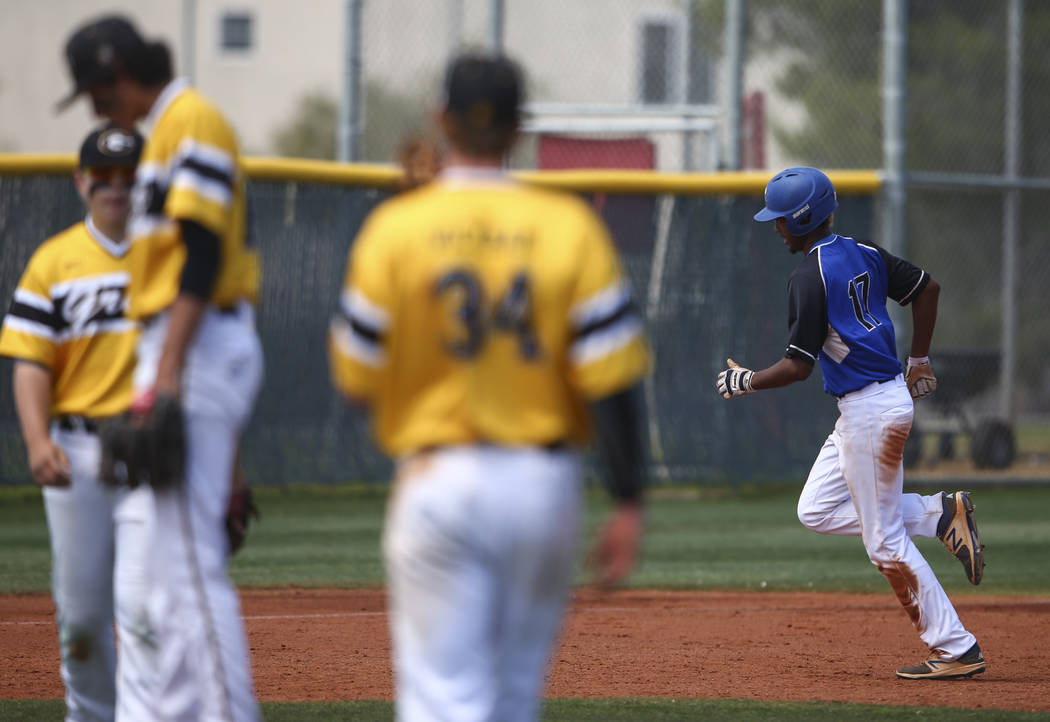 Basic’s Garrett Giles (17) rounds the bases on a home run against Galena during a Clas ...