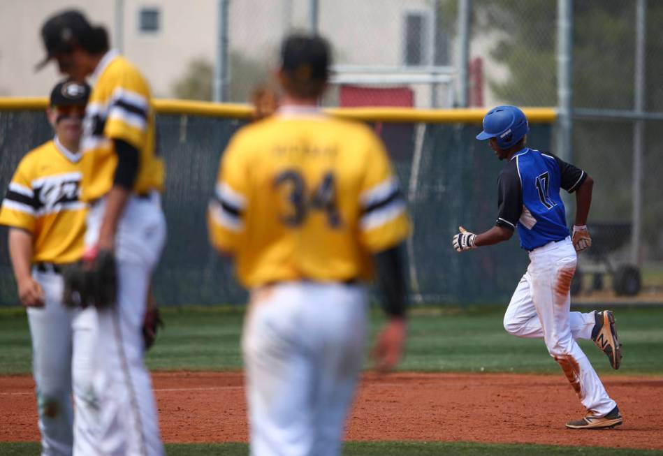 Basic’s Garrett Giles (17) rounds the bases on a home run against Galena during a Clas ...