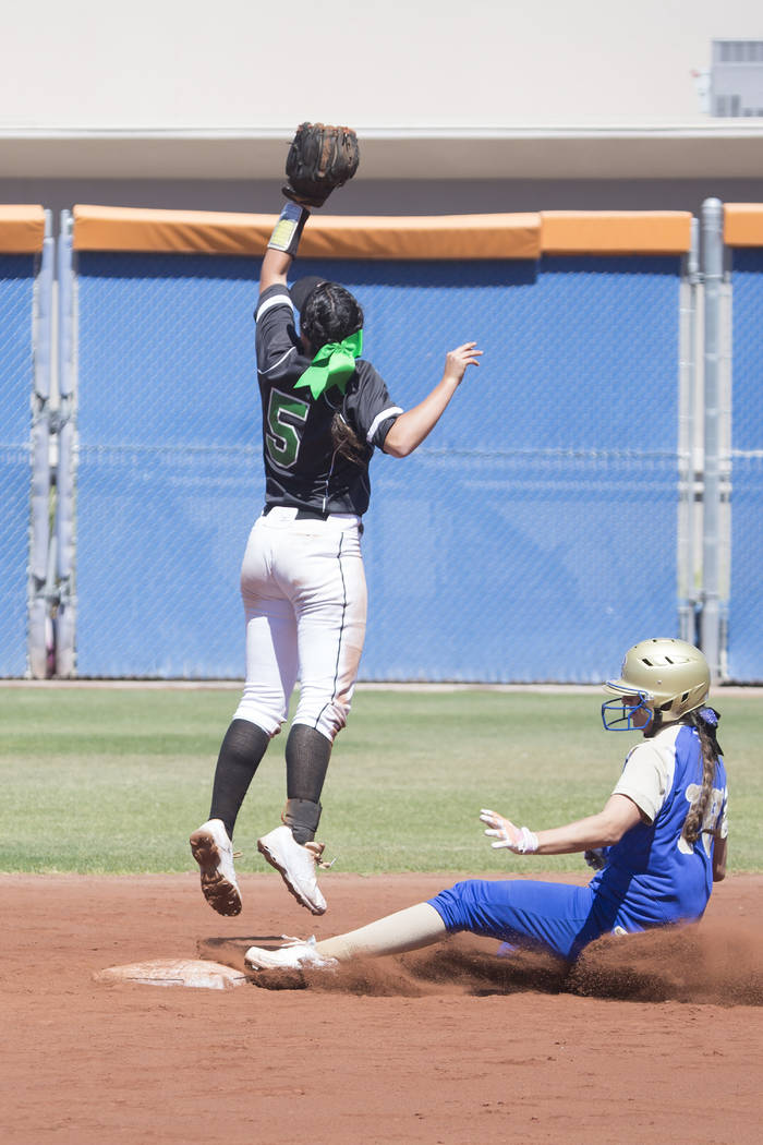 Palo Verde junior Lauryn Barker, left, jumps for the ball as Reed senior Allie Hughes slides ...