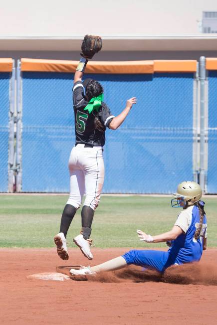 Palo Verde junior Lauryn Barker, left, jumps for the ball as Reed senior Allie Hughes slides ...