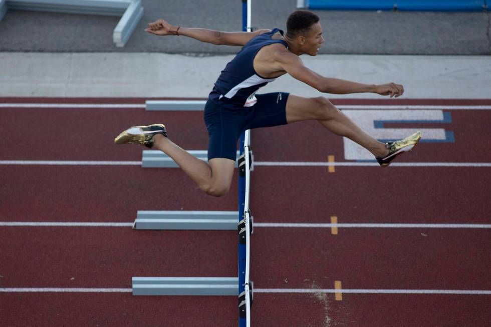 Legacy senior Jamaal Britt takes the lead during the boys 300-meter hurdles at the NIAA Stat ...