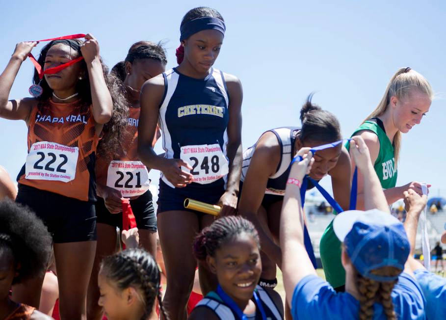 Cheyenne runners receive their medals in the girls 400-meter relay during the NIAA 3A State ...