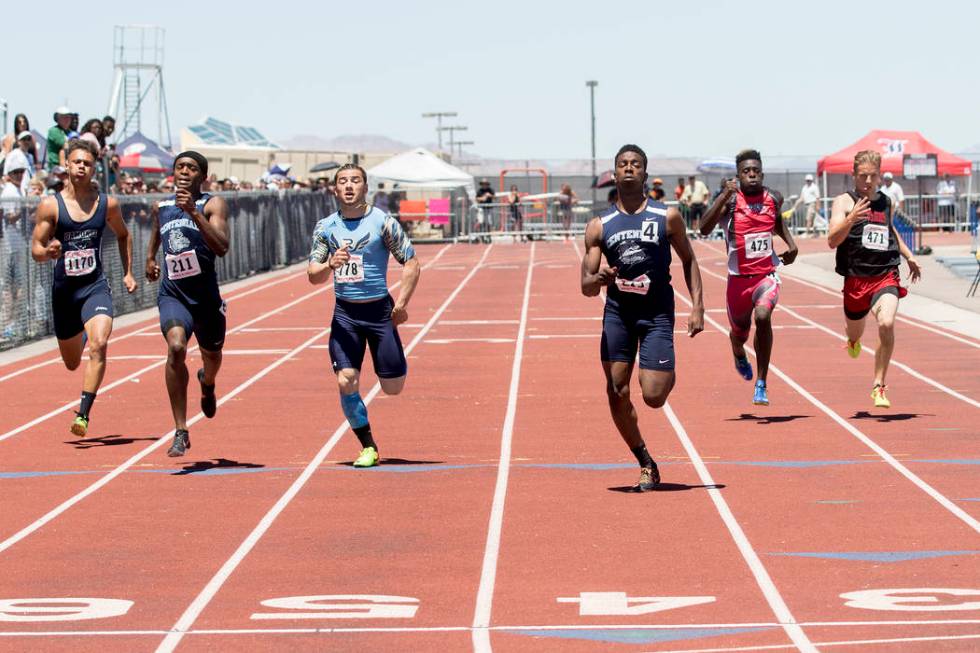 Centennial senior Savon Scarver takes the lead in the boys 200-meter dash during the NIAA St ...