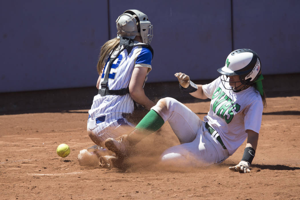 Palo Verde’s Cara Beatty (5) slides home for a run against Reed’s Jilian Kygar ( ...