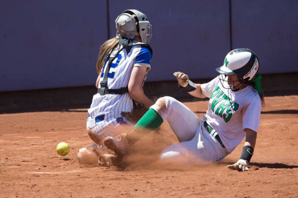 Palo Verde’s Cara Beatty (5) slides home for a run against Reed’s Jilian Kygar ( ...