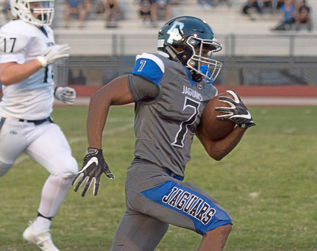 Desert Pines High School’s Isaiah Morris (7) runs the ball upfield to score a touchdow ...