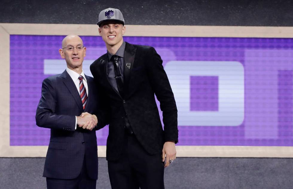 Zach Collins poses for photos with NBA Commissioner Adam silver after being selected by the ...