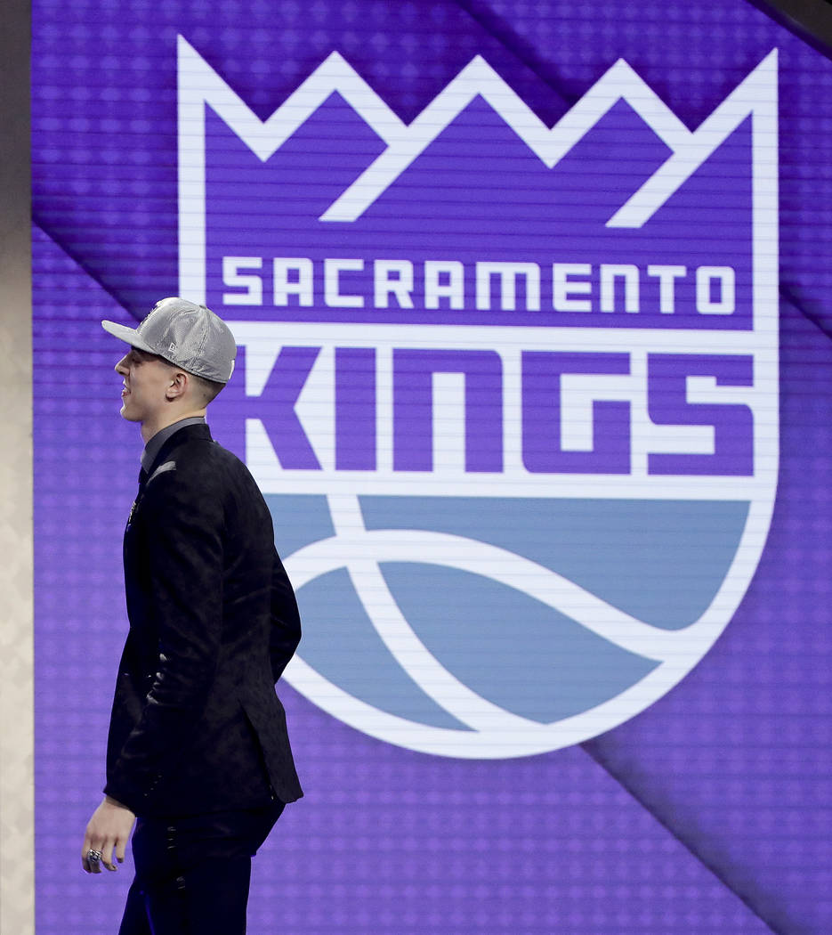 Zach Collins walks up on stage after being selected by the Sacramento Kings as the 10th pick ...