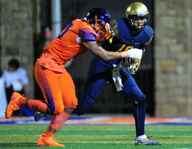 St. Thomas Aguinas, Fla. Trevon Grimes grabs the facemask of Bishop Gorman offensive lineba ...