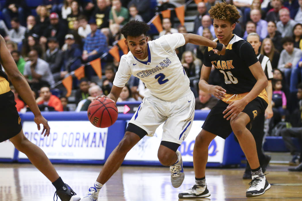 Bishop Gorman Jamal Bey (2) drives to the basket past Clark forward Jalen Hill (20) during a ...