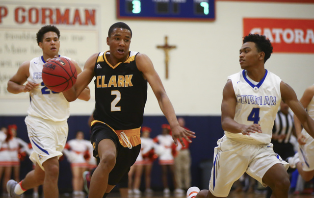 Clark guard Sedrick Hammond (2) drives past Bishop Gorman guard D.J. Howe (4) during a baske ...