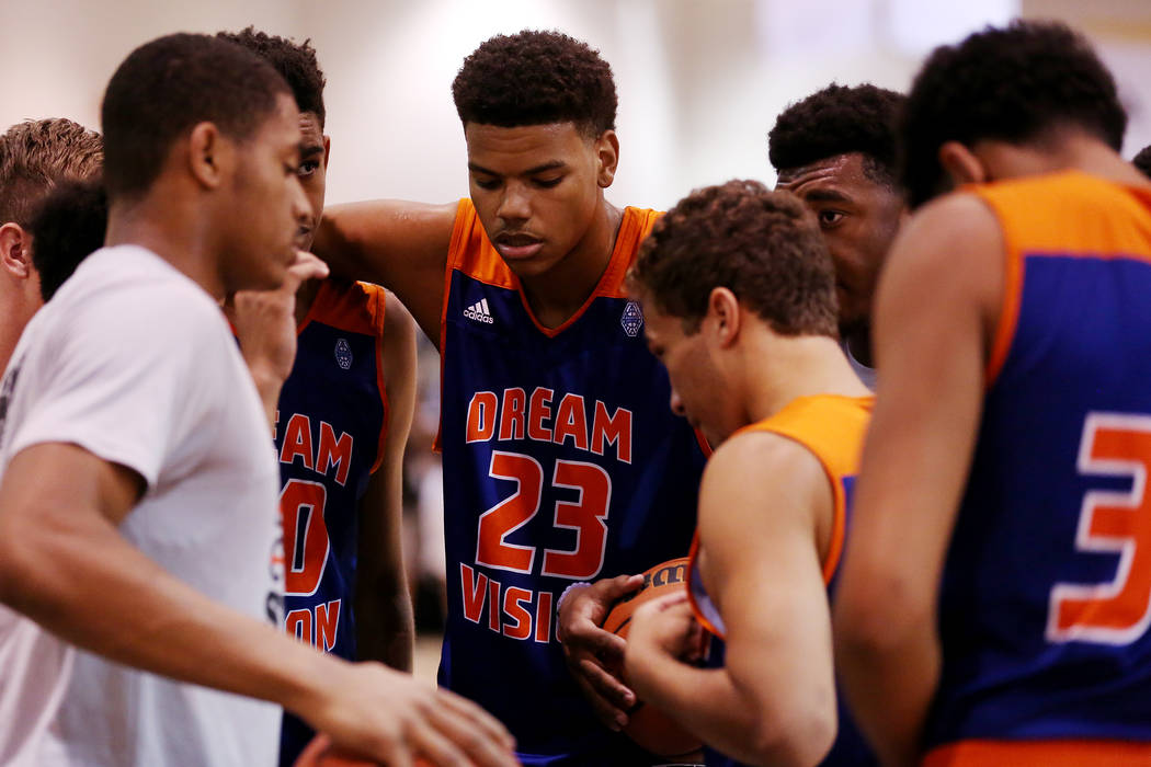 Dream Vision player Bryan Penn-Johnson huddles with his teammates during an Adidas Summer Ch ...