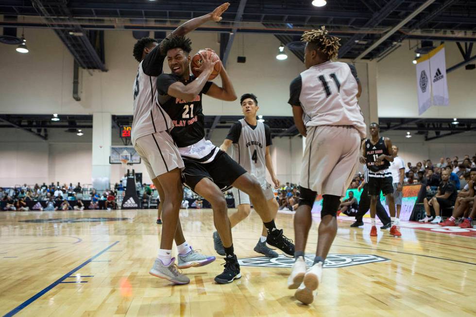 Play Hard Play Smart player Jordan Brown brings the ball to the basket during an Adidas Summ ...