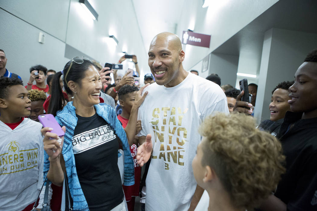 Fans swarm Big Baller Brand AAU team coach LaVar Ball after an Adidas Summer Championship AA ...