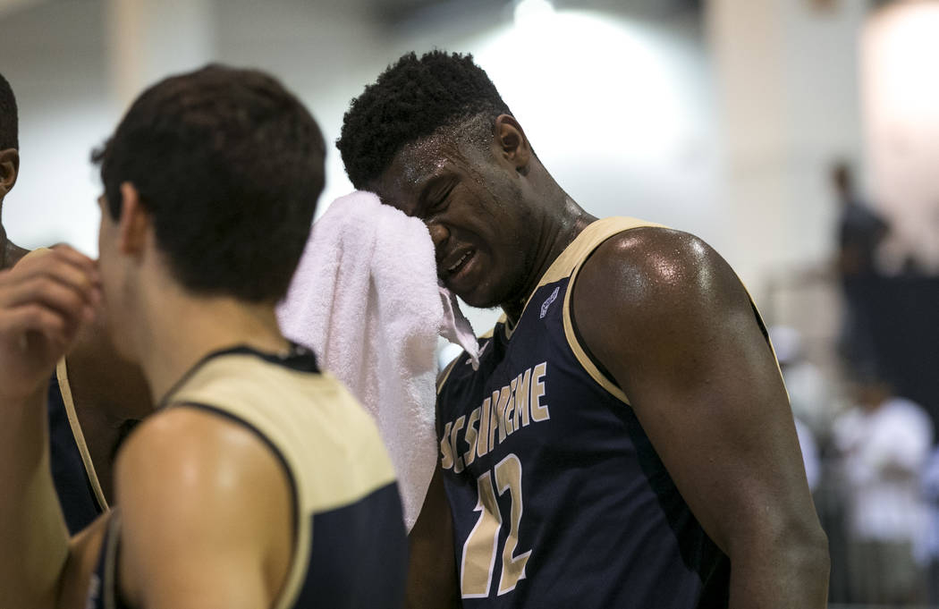 SC Supreme forward Zion Williamson (12) wipes his brow on a time out against Play Hard Play ...