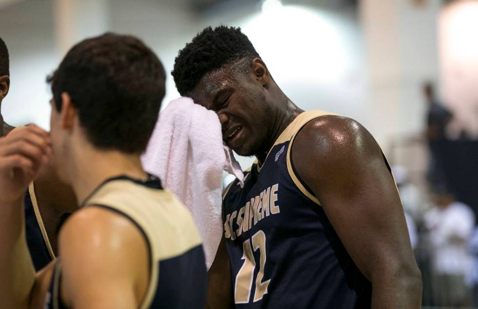 SC Supreme forward Zion Williamson (12) wipes his brow on a time out against Play Hard Play ...