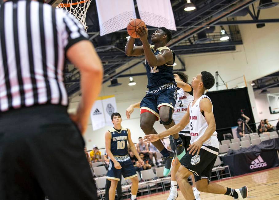 SC Supreme forward Zion Williamson (12) goes up for a shot over Play Hard Play Smart’s ...