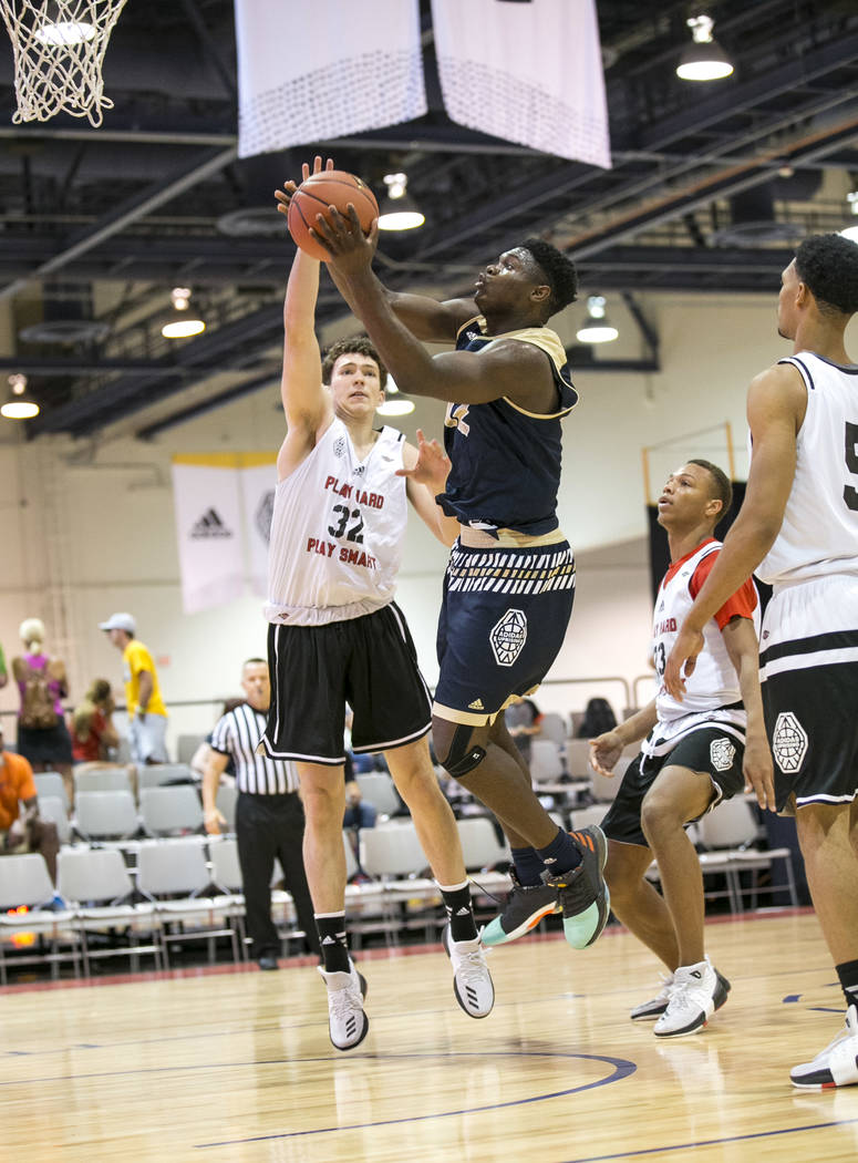 SC Supreme forward Zion Williamson (12) takes a shot under pressure from Play Hard Play Smar ...