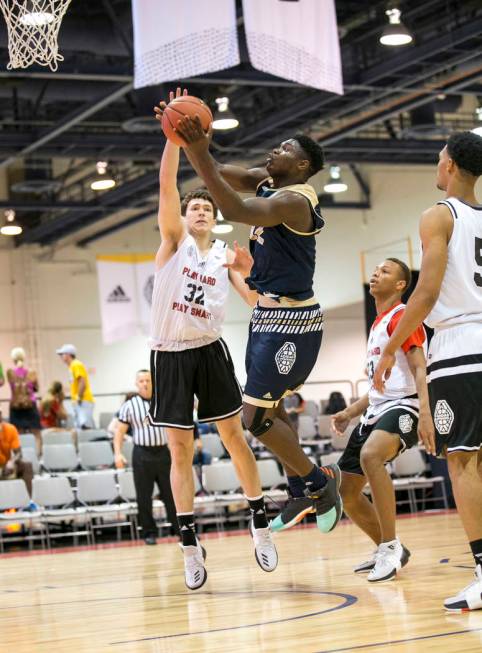 SC Supreme forward Zion Williamson (12) takes a shot under pressure from Play Hard Play Smar ...