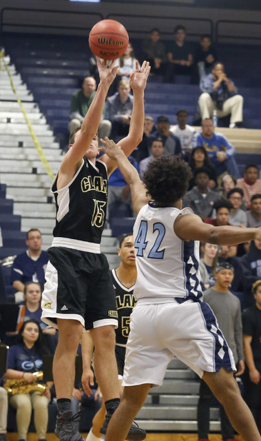 Clark’s James Bridges (15) shoots over Centennial’s Jamaal Evans (42) during the ...